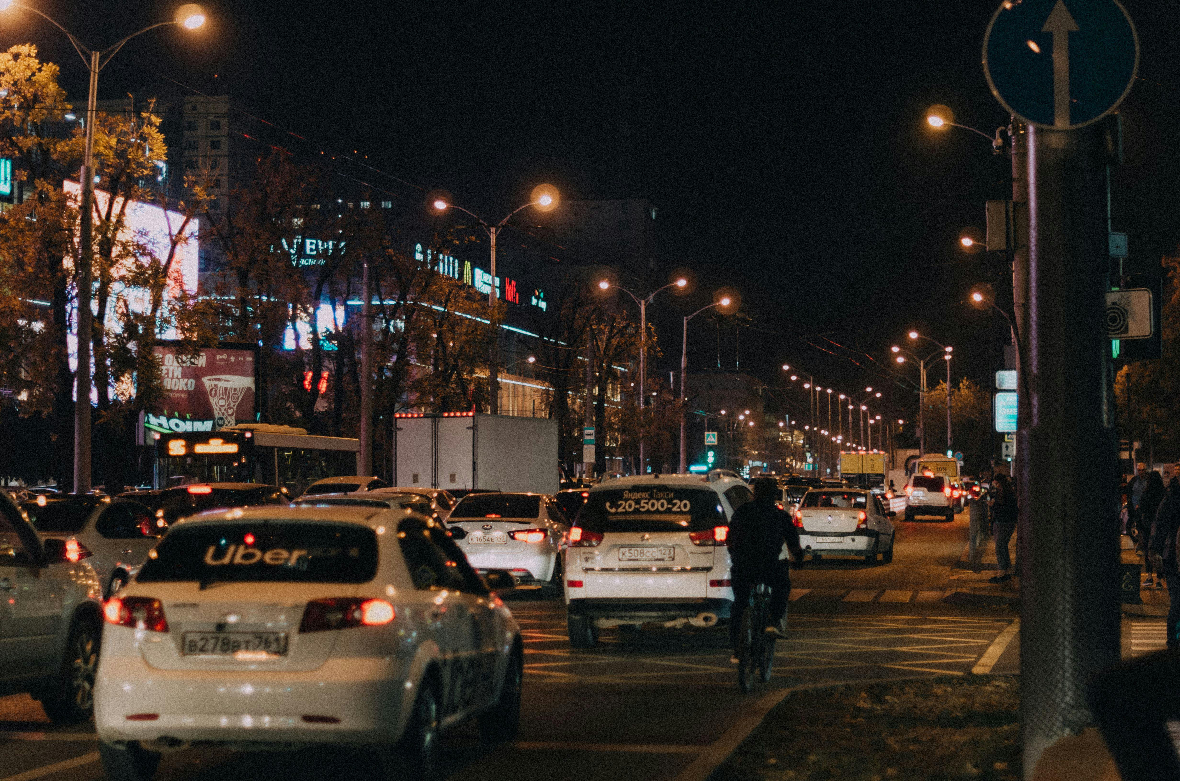 A vehicle with "Uber" written on the rear window in traffic